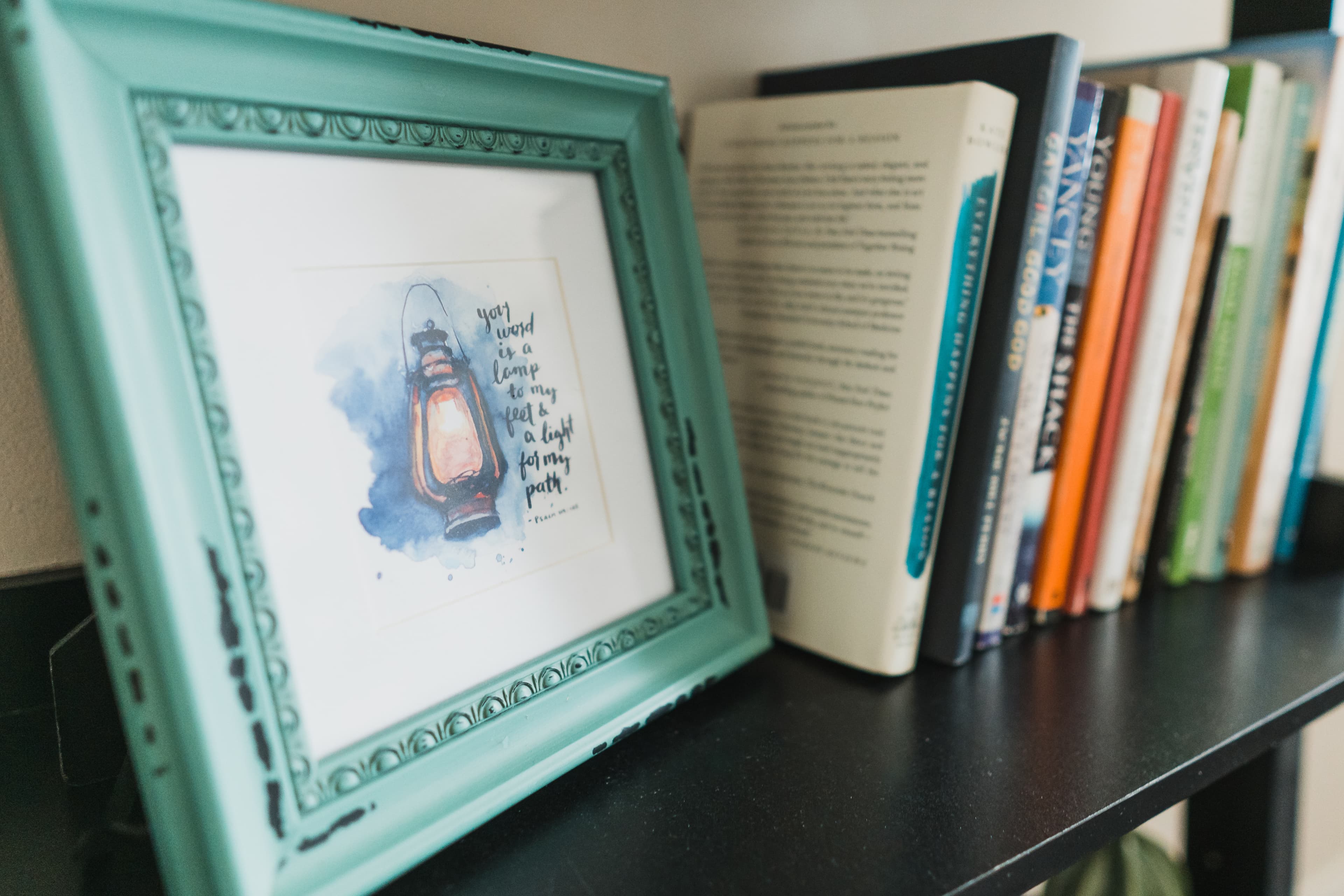 a picture and books on a shelf