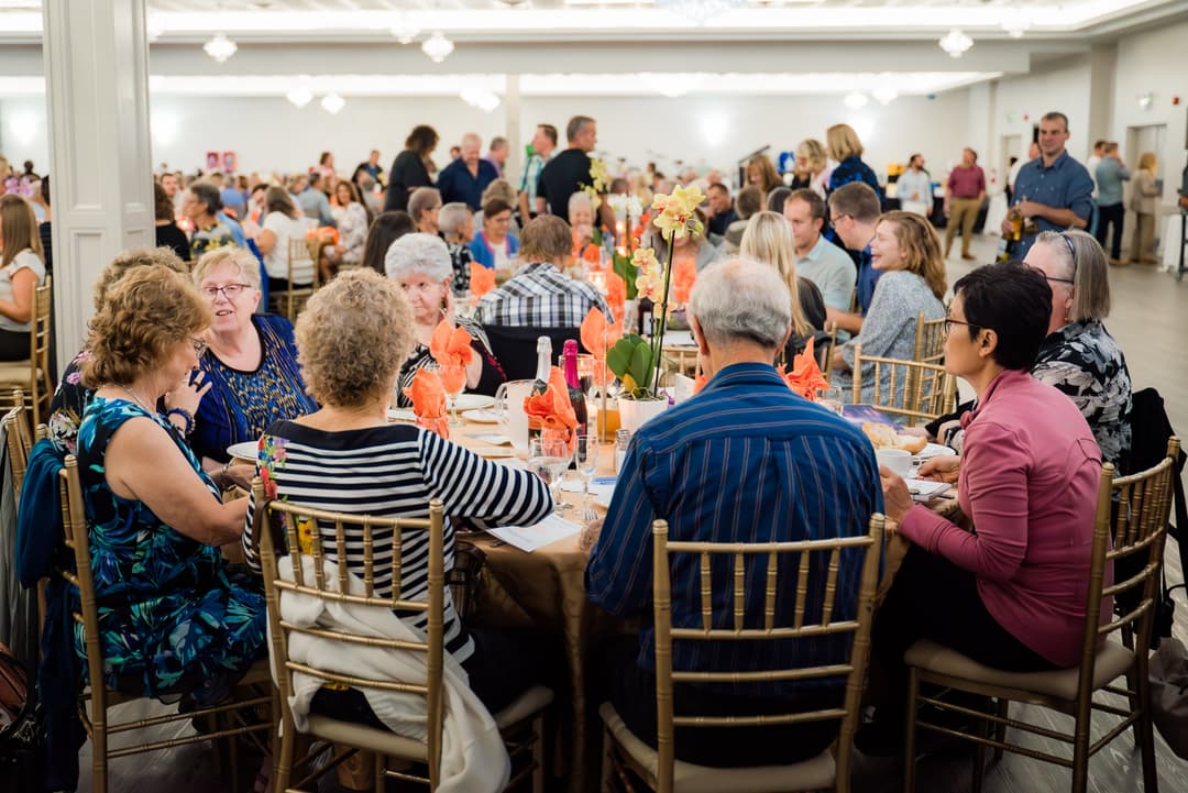 a fundraiser event with people sitting at tables