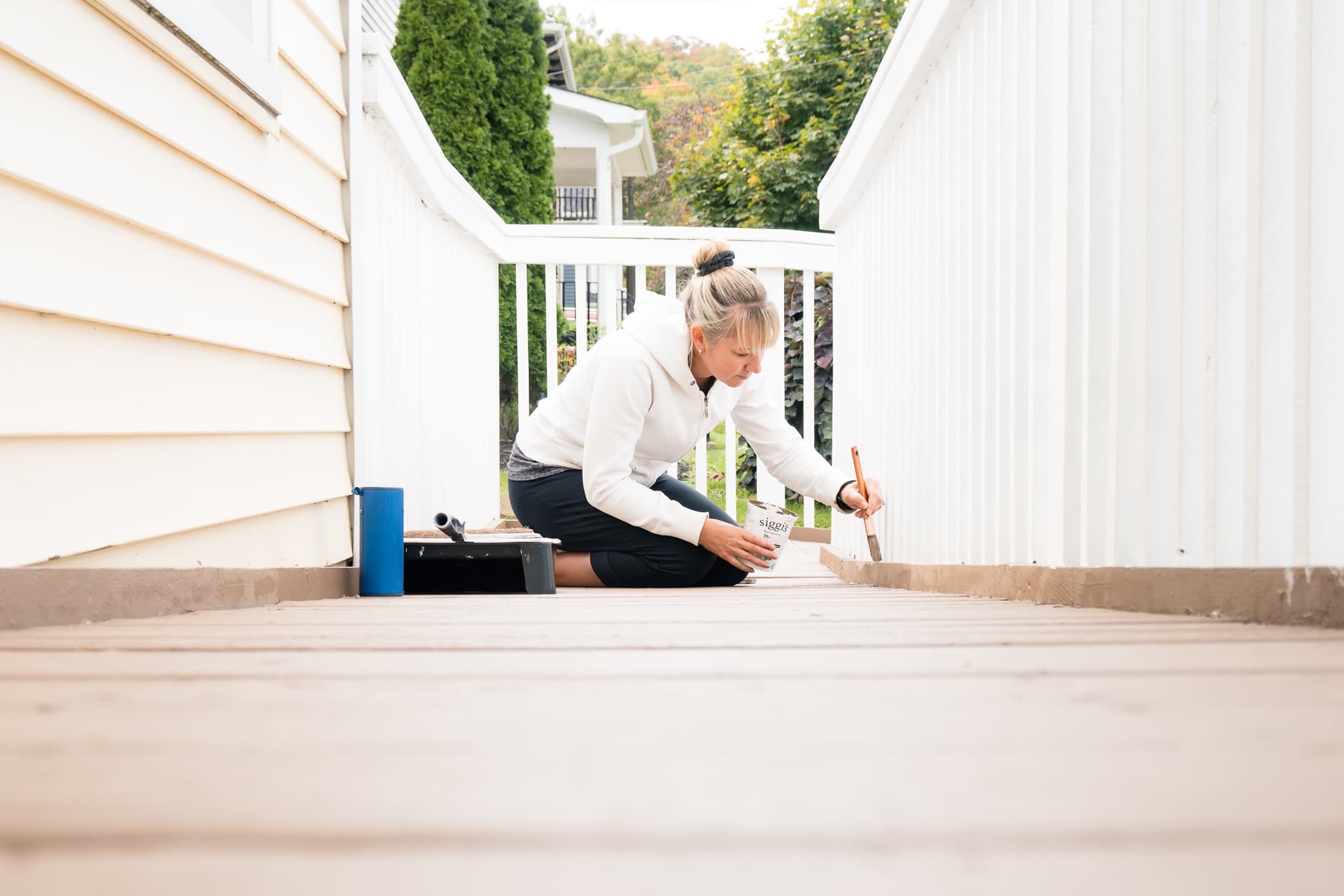 a volunteer painting a walkway